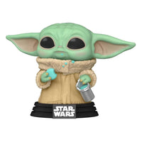 Funko POP Grogu vinyl figure from Star Wars, holding a blue cookie and a silver bucket on a black display stand.