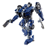 Hasbro Transformers Studio Series Barricade action figure in blue and grey robot mode holding two weapon accessories.