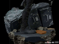 Close-up of the black tactical boots on an Iron Studios Black Widow 1/10 scale statue standing on a rubble base.