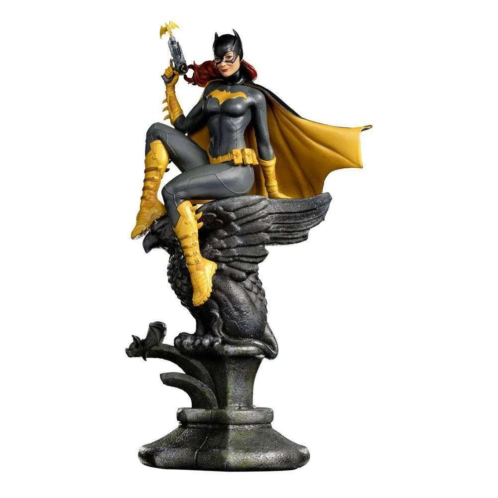 Iron Studios 1/10 Batgirl Deluxe Art Scale statue in a grey and yellow suit, perched on a stone gargoyle base.