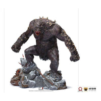 Iron Studios God of War Ogre 1/10 scale statue in a dynamic pose on a rocky base with detailed dark skin and spikes.