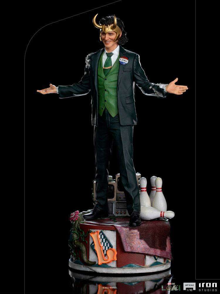 Iron Studios Loki President Variant 1/10 scale statue in a green suit with horned helmet, standing on a themed base.