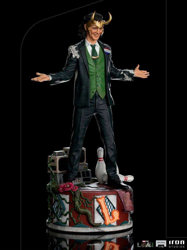 Iron Studios 1/10 Loki President Variant statue in a green vest and suit, standing on a detailed, themed display base.