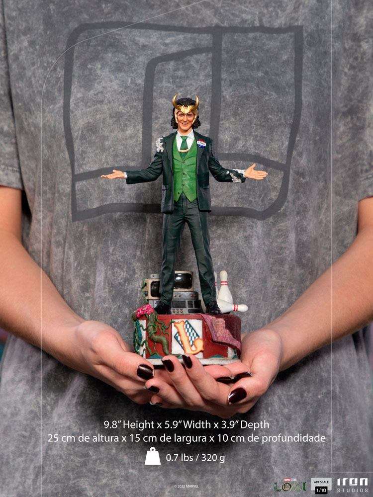 Iron Studios Loki President Variant 1/10 scale statue in a green suit with horned helmet, held in hands.