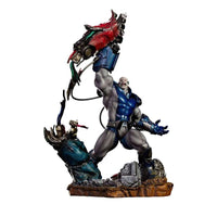 Iron Studios 1/10 Apocalypse Deluxe statue in blue and grey armor, lifting a mechanical arm on a rocky debris base.