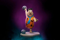 Iron Studios 17 cm Fred Flintstone Art Scale statue showing Fred in his iconic orange tunic holding a bowling ball.